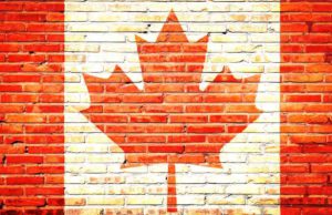 Ohne eTA keine Einreise in Kanada! Kanada: Mauer mit aufgemalter kanadischer Fahne