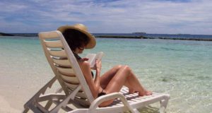 Flugausfall: Entschädigung für verkürzte Fernreise! Fernreise: Frau auf Sonnenliege am Strand auf den Malediven