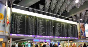 Flug verspätet? Was Sie dann tun sollten! Flug verspätet? Entschädigung bei Flugverspätung können sofort geltend gemacht werden. Passagiere vor Anzeigetafeln am Flughafen