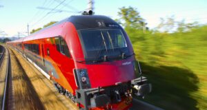 Sparschiene für klimafreundliches Reisen Klimafreundliche reisen mit der Sparschiene: Bild zeigt einen roten Railjet in voller Fahrt