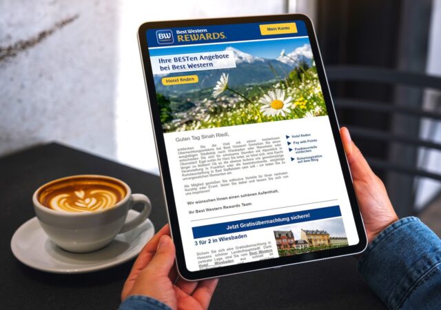 BWH Hotels: Mockup image of a woman holding digital tablet with blank white desktop screen in cafe