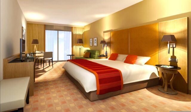 ehotel als bester Mittelstandsdienstgleiter in der Kategorie Hotelportl: Hotelzimmer mit roter Decke auf dem Bett mit angenehmer Beleuchtung